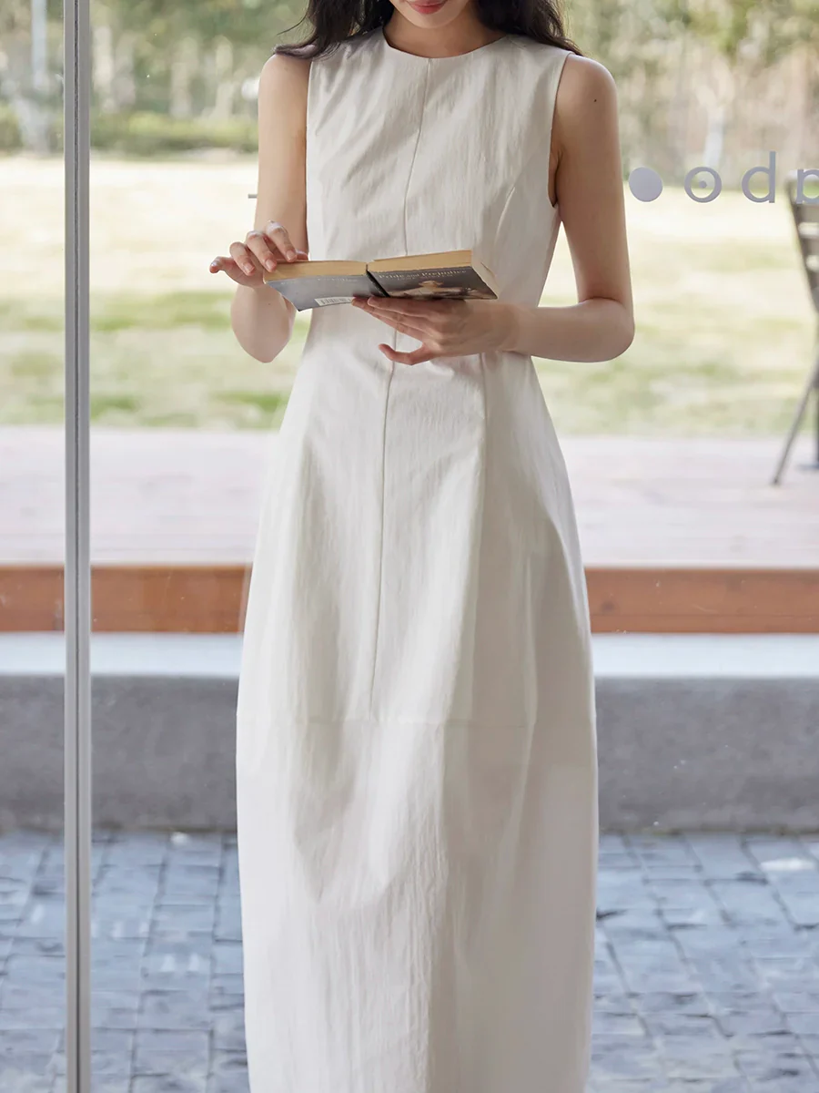 Sleeveless Maxi Dress Paired with a Woven Straw Handbag - Image 2