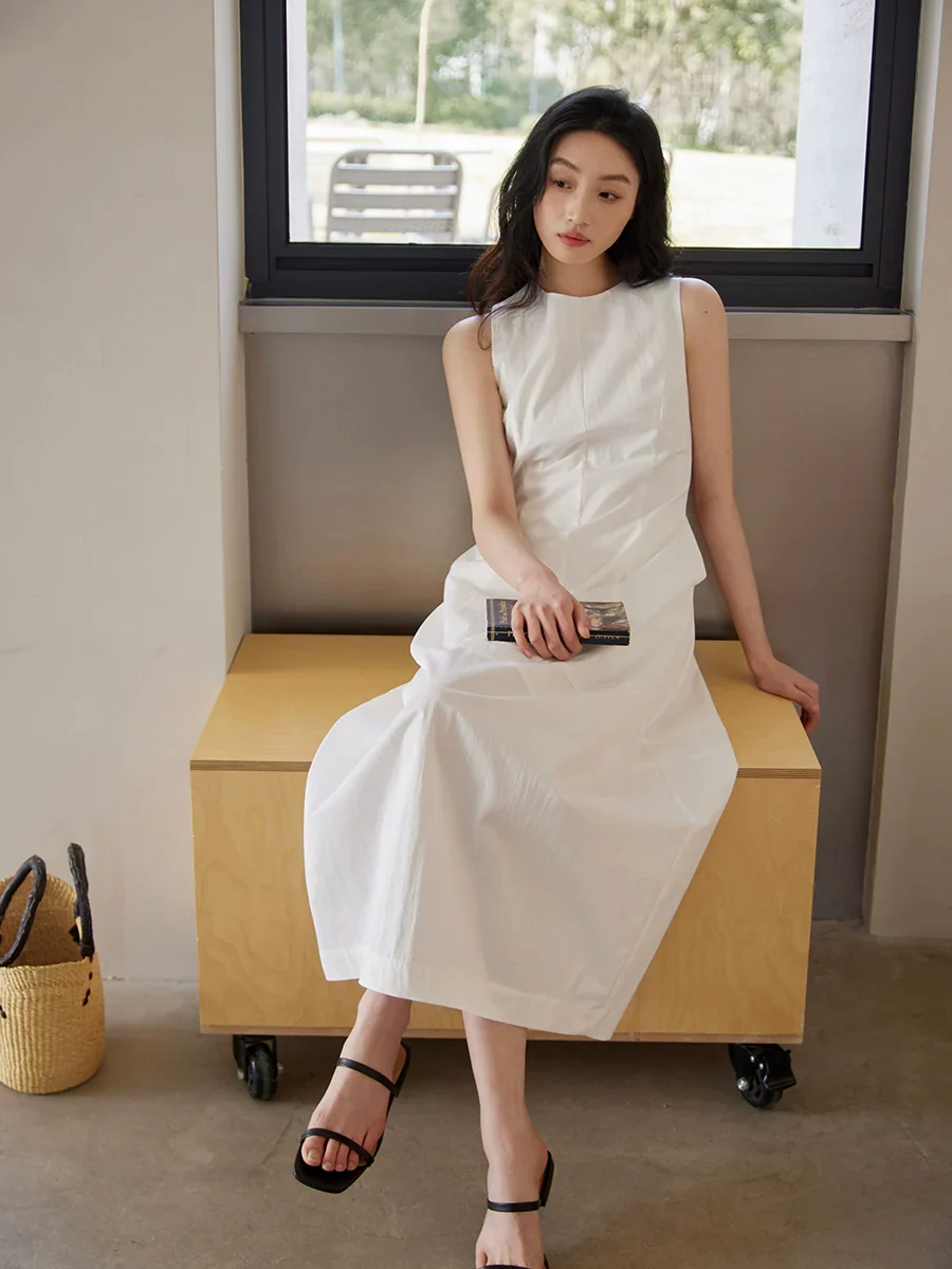 Sleeveless Maxi Dress Paired with a Woven Straw Handbag - Image 3